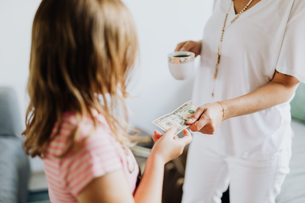 Mother Teaching Kid About Money